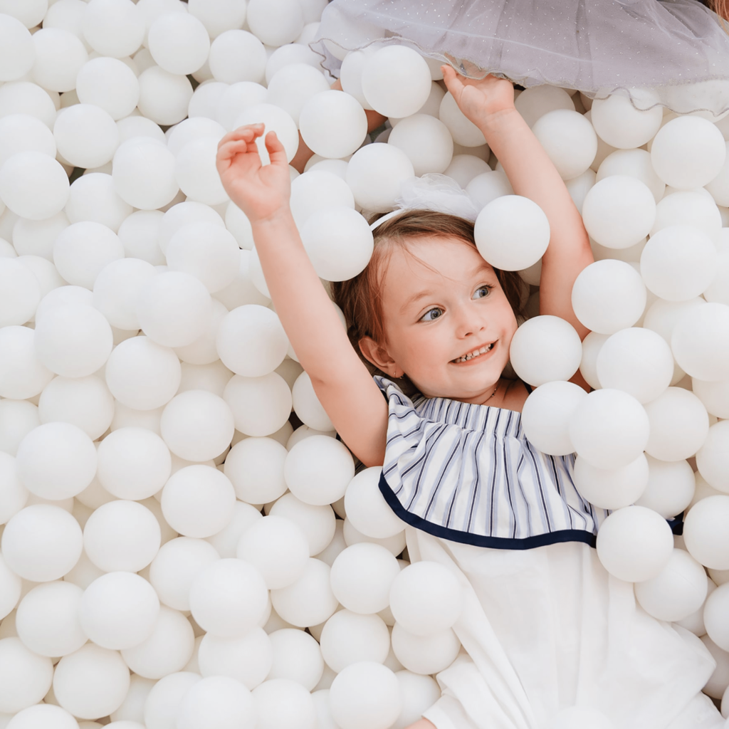 Girl in White Ball Pit