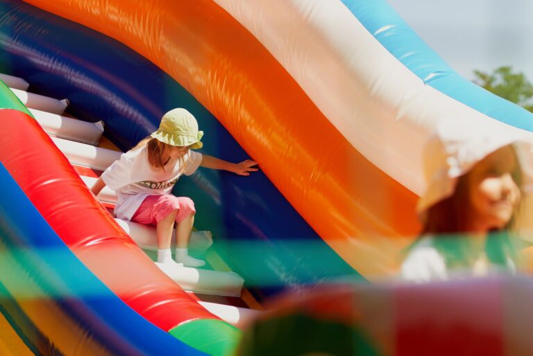 Girl sliding down a bounce house